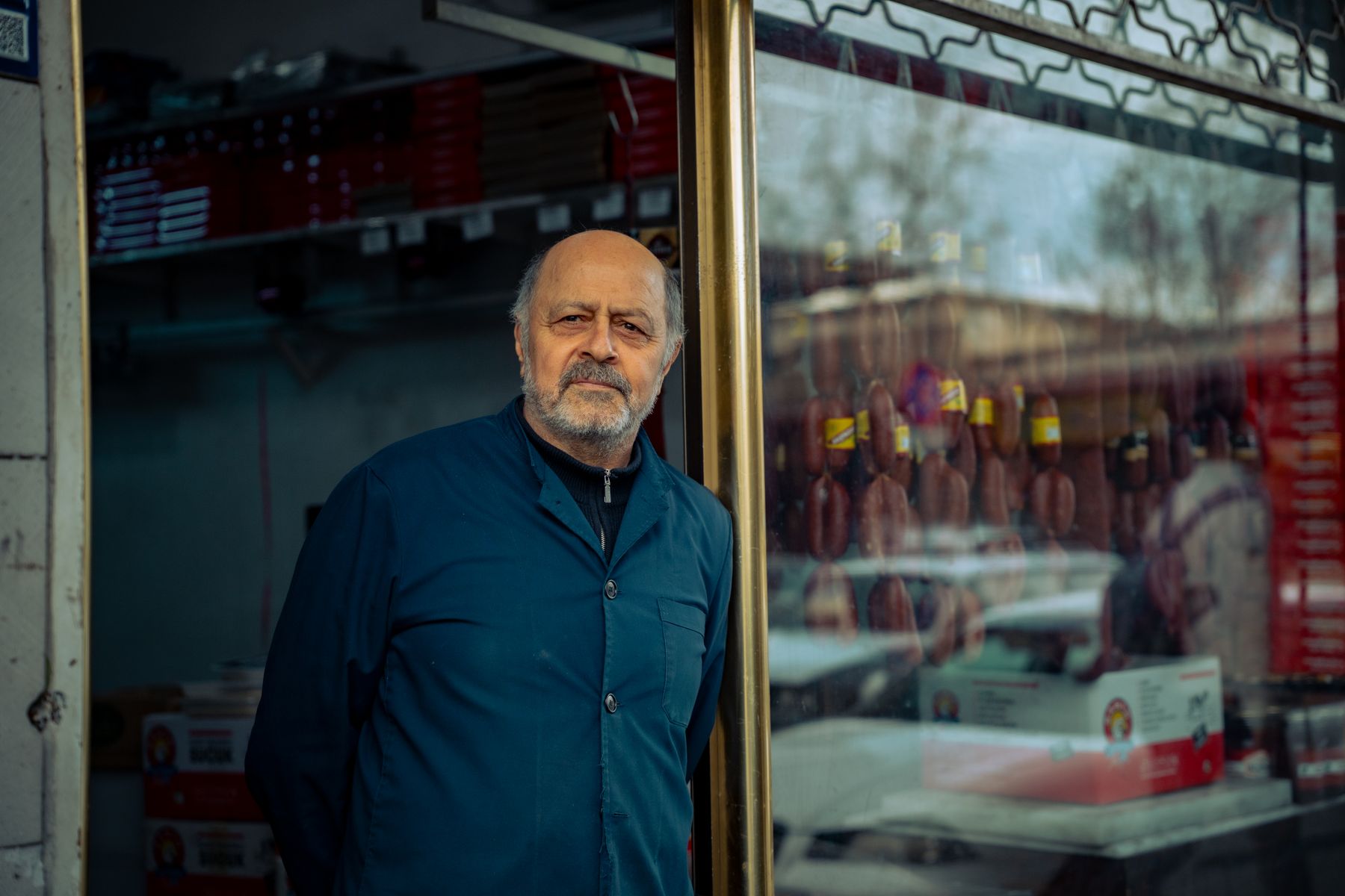 A shop owner outside his storefront